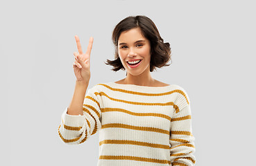 Image showing happy smiling woman showing peace or two fingers