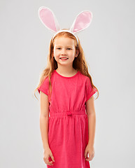 Image showing happy red haired girl wearing easter bunny ears