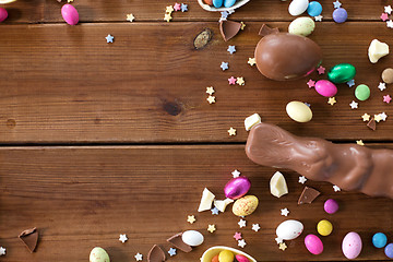 Image showing chocolate eggs, easter bunny and candies on wood