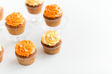 Image showing cupcakes with frosting on confectionery stands