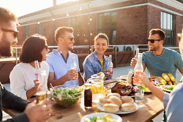 Image showing happy friends with drinks or bbq party on rooftop