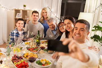 Image showing family having dinner party and taking selfie