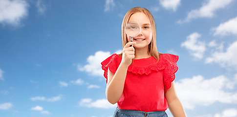 Image showing happy girl looking through magnifying glass