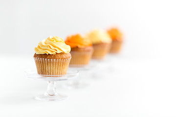 Image showing cupcakes with frosting on confectionery stands