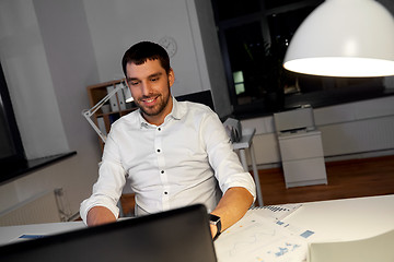 Image showing businessman with laptop working at night office