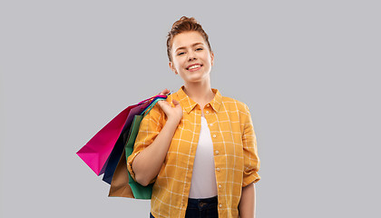 Image showing smiling red haired teenage girl with shopping bags