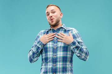 Image showing The happy business man standing and smiling against blue background.