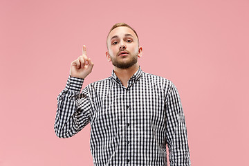 Image showing The happy business man standing and smiling against pink background.