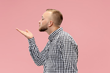 Image showing Portrait of attractive man with kiss isolated over pink background