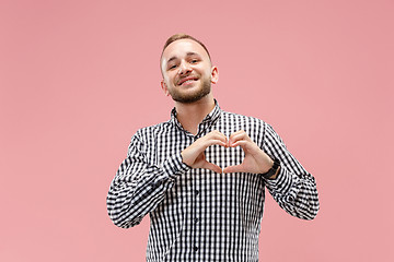 Image showing Portrait of attractive man with kiss isolated over pink background