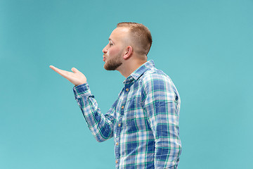 Image showing Portrait of attractive man with kiss isolated over blue background