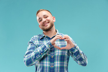 Image showing Portrait of attractive man with kiss isolated over blue background