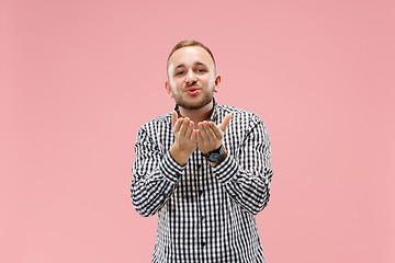 Image showing Portrait of attractive man with kiss isolated over pink background