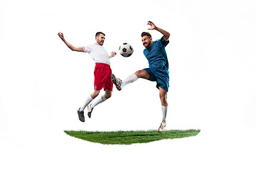 Image showing Football players tackling for the ball over white background