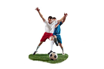 Image showing Football players tackling for the ball over white background