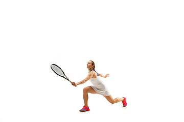 Image showing Adult woman playing tennis. Studio shot over white.