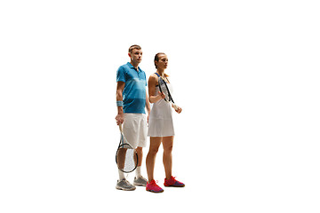 Image showing caucasian man and woman as tennis players posing isolated on white background