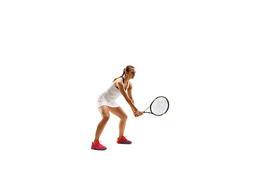 Image showing Adult woman playing tennis. Studio shot over white.