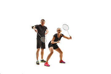 Image showing couple playing with badminton rackets isolated on white