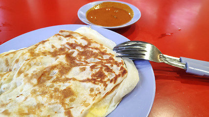 Image showing Roti canai with curry sauce 
