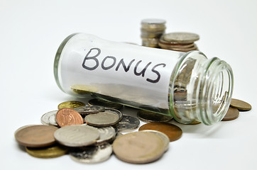 Image showing Bonus lable in a glass jar with coins spilling out