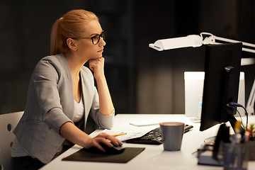 Image showing businesswoman at computer working at night office