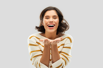 Image showing smiling young woman holding empty palms