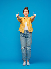 Image showing happy red haired teenage girl showing thumbs up