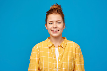 Image showing smiling red haired teenage girl in checkered shirt
