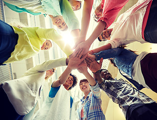 Image showing group of international students with hands on top