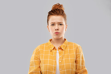 Image showing sad red haired teenage girl in shirt pouting