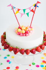 Image showing close up of birthday cake with garland on stand