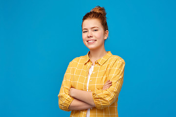 Image showing smiling red haired teenage girl with crossed arms