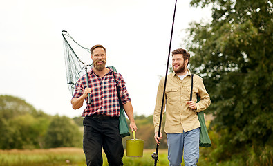 Image showing friends with fishing rods and net walking outdoors