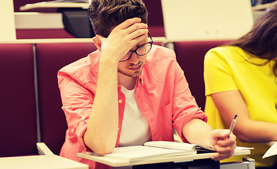 Image showing group of students with notebooks in lecture hall