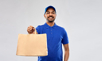 Image showing happy indian delivery man with food in paper bag