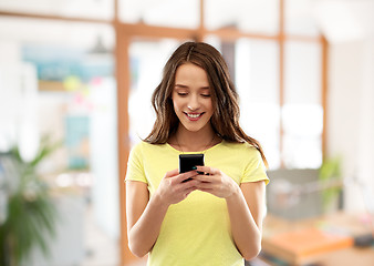 Image showing young woman or teenage girl using smartphone