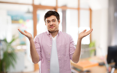 Image showing young man shrugging over office room