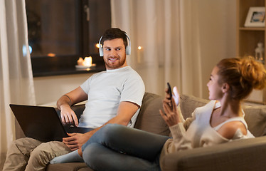 Image showing couple with laptop and smartphone resting at home