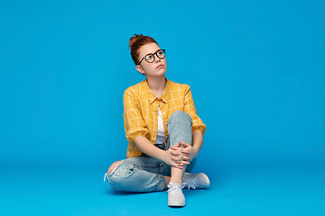 Image showing redhead teenage student girl in glasses dreaming