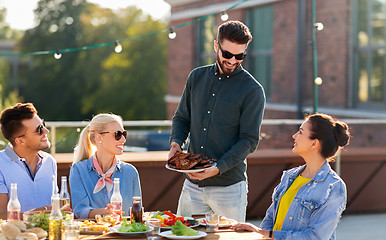 Image showing friends at bbq party on rooftop in summer