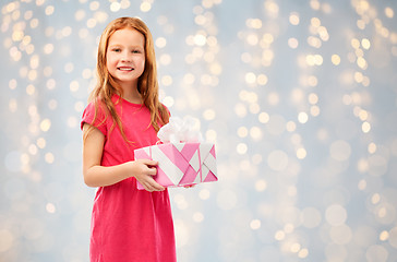 Image showing smiling red haired girl with birthday gift