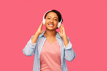 Image showing african woman in headphones listening to music