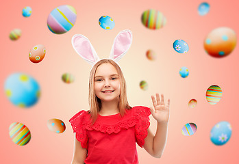 Image showing happy girl wearing easter bunny ears waving hand