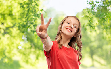 Image showing smiling teenage girl in red t-shirt showing peace