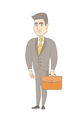 Image showing Young caucasian businessman holding briefcase.