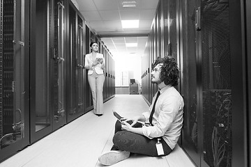 Image showing young technicians working together on servers