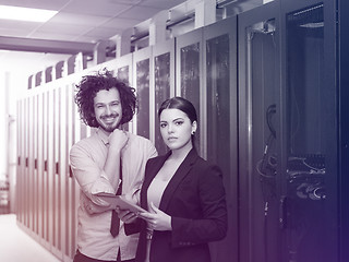 Image showing engineer showing working data center server room to female chief