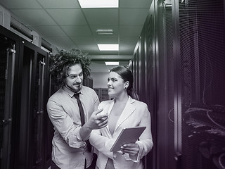 Image showing engineer showing working data center server room to female chief