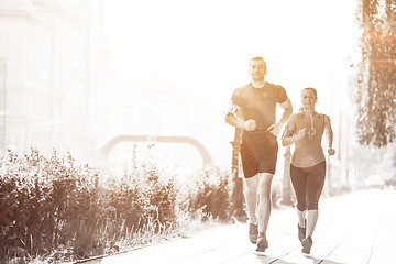 Image showing young couple jogging  in the city